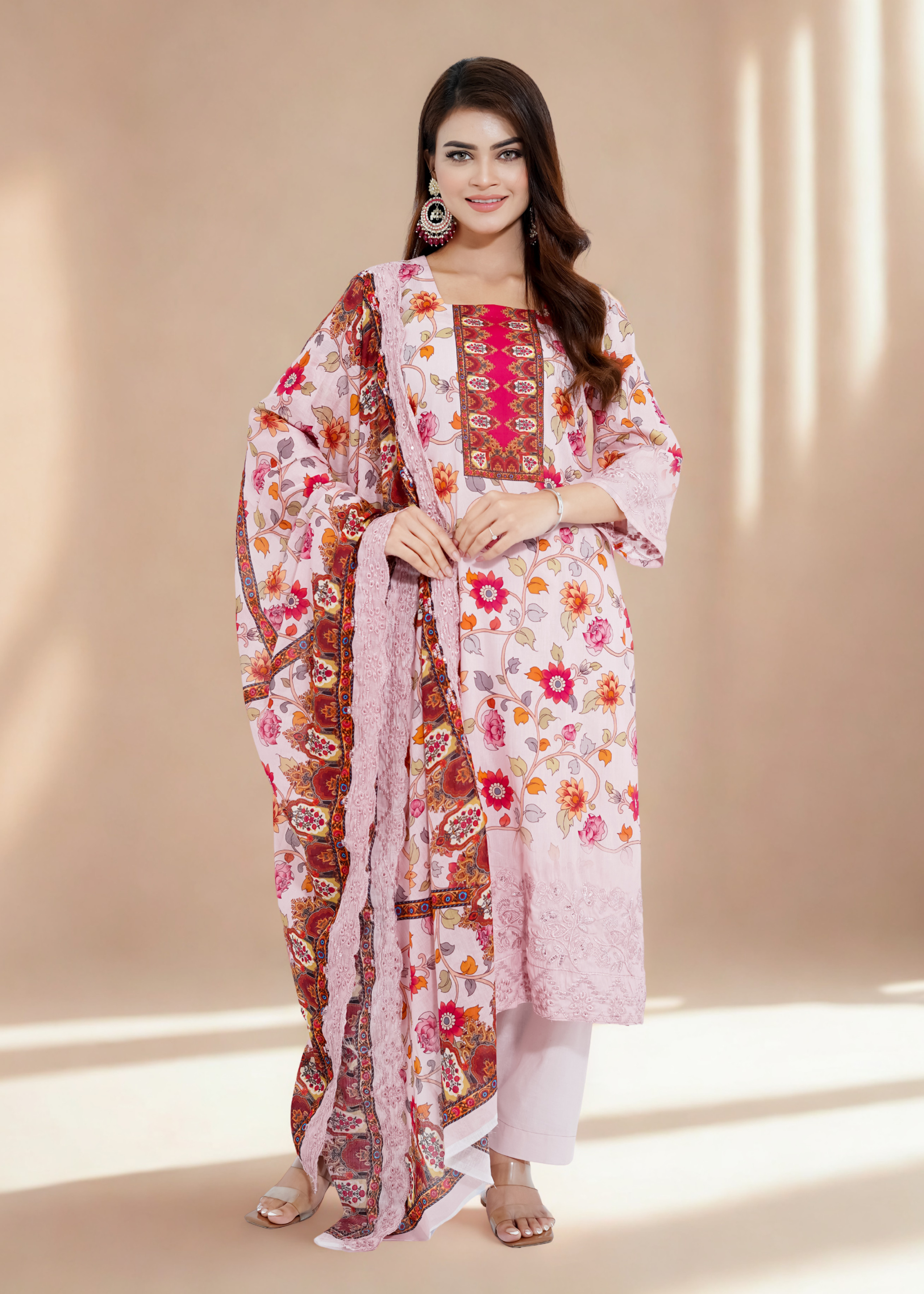 Woman wearing a floral dupatta with a plain background